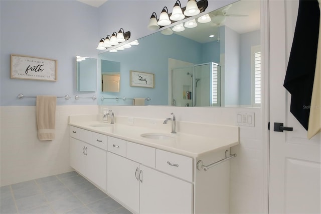 14647 Potterton Cir, Hudson, FL 34667 - full bath featuring double vanity, a stall shower, tile patterned floors, and tile walls