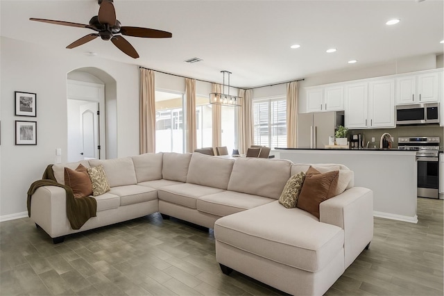 14647 Potterton Cir, Hudson, FL 34667 - living room with recessed lighting, light wood-style flooring, ceiling fan, and arched walkways