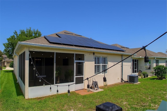 14647 Potterton Cir, Hudson, FL 34667 - rear view of property with a sunroom, solar panels, a yard, and stucco siding