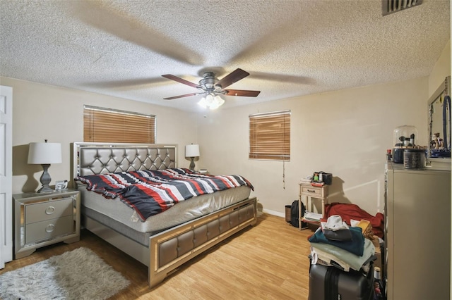 6428 Kentfield Ave, New Port Richey, FL 34653 - bedroom featuring wood finished floors, a textured ceiling, and a ceiling fan