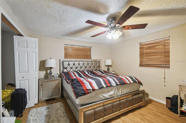 6428 Kentfield Ave, New Port Richey, FL 34653 - bedroom with a textured ceiling, wood finished floors, and ceiling fan