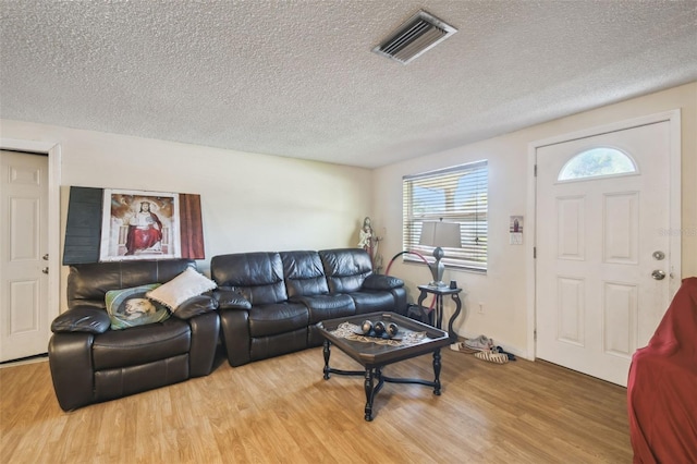 6428 Kentfield Ave, New Port Richey, FL 34653 - living area with wood finished floors and a textured ceiling
