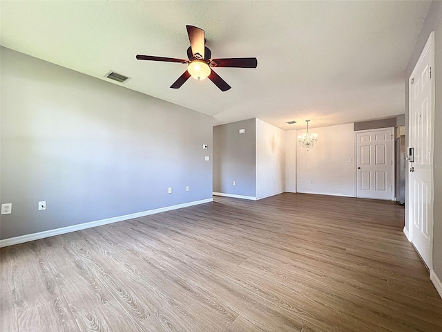 12214 Partridge Hill Row, Hudson, FL 34667 - spare room featuring a chandelier, a ceiling fan, and wood finished floors