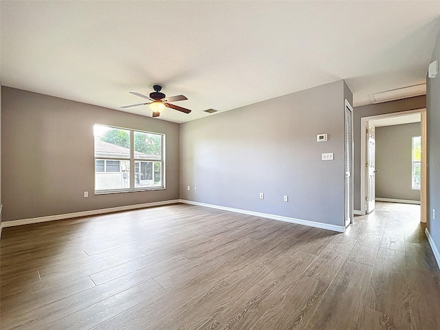 12214 Partridge Hill Row, Hudson, FL 34667 - empty room with wood finished floors and ceiling fan