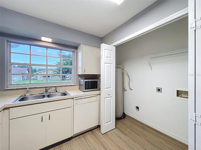 12214 Partridge Hill Row, Hudson, FL 34667 - washroom with light wood-type flooring, hookup for a washing machine, and hookup for an electric dryer