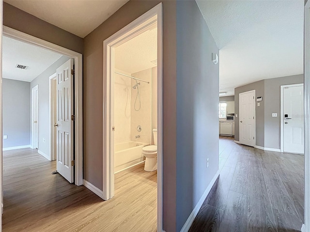 12214 Partridge Hill Row, Hudson, FL 34667 - hallway featuring wood finished floors