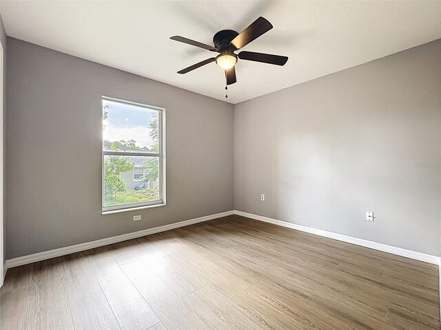 12214 Partridge Hill Row, Hudson, FL 34667 - unfurnished room featuring wood finished floors and ceiling fan