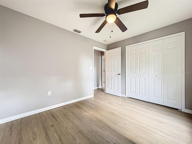 12214 Partridge Hill Row, Hudson, FL 34667 - unfurnished bedroom with wood finished floors, a closet, and ceiling fan