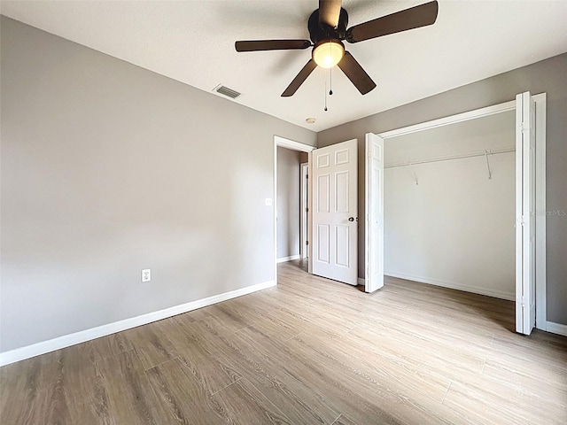 12214 Partridge Hill Row, Hudson, FL 34667 - unfurnished bedroom featuring wood finished floors, a closet, and a ceiling fan