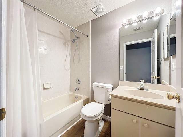 12214 Partridge Hill Row, Hudson, FL 34667 - full bath featuring shower / tub combo with curtain, wood finished floors, a textured ceiling, vanity, and a textured wall