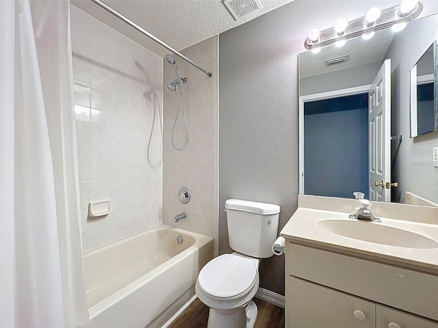 12214 Partridge Hill Row, Hudson, FL 34667 - bathroom featuring shower / tub combo with curtain, vanity, wood finished floors, a textured ceiling, and a textured wall