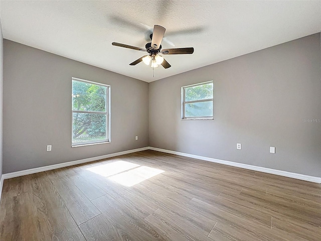 12214 Partridge Hill Row, Hudson, FL 34667 - empty room featuring wood finished floors and a ceiling fan