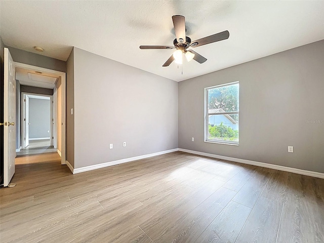 12214 Partridge Hill Row, Hudson, FL 34667 - spare room featuring a ceiling fan, wood finished floors, a smoke detector, and attic access