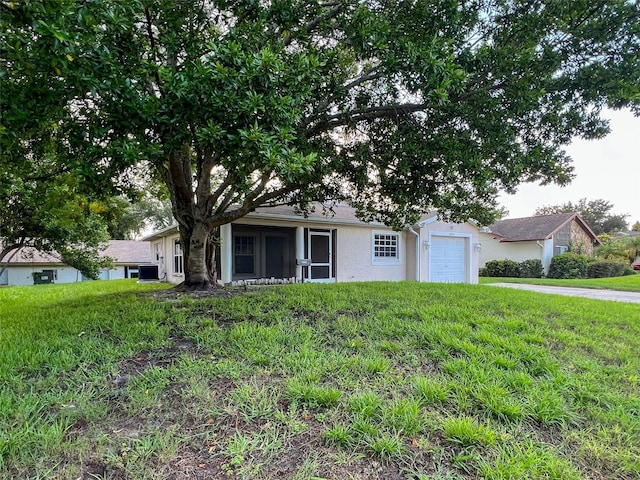 12214 Partridge Hill Row, Hudson, FL 34667 - view of front of property featuring stucco siding, an attached garage, and a front yard