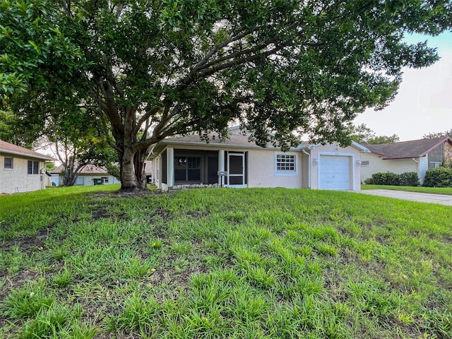 12214 Partridge Hill Row, Hudson, FL 34667 - view of front of house with stucco siding, a garage, concrete driveway, and a front yard