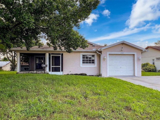 12214 Partridge Hill Row, Hudson, FL 34667 - ranch-style home featuring stucco siding, a garage, concrete driveway, and a front lawn