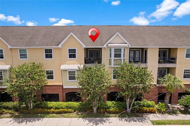 2010 E Palm Ave Unit 14312, Tampa, FL 33605 - view of front of house featuring stucco siding, brick siding, and roof with shingles