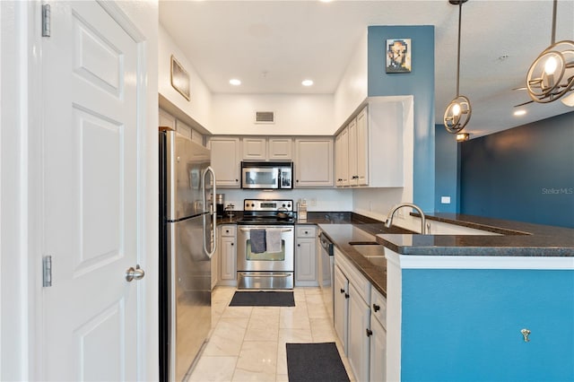 2010 E Palm Ave Unit 14312, Tampa, FL 33605 - kitchen with appliances with stainless steel finishes, dark countertops, a peninsula, pendant lighting, and recessed lighting