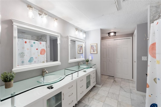 2010 E Palm Ave Unit 14312, Tampa, FL 33605 - bathroom with marble look tiles, double vanity, and a textured ceiling
