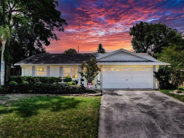 8640 Horizon Ln, Hudson, FL 34667 - ranch-style house featuring driveway, a front lawn, an attached garage, and stucco siding