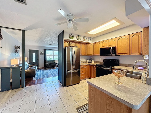 8640 Horizon Ln, Hudson, FL 34667 - kitchen featuring electric range, freestanding refrigerator, a peninsula, ceiling fan, and light tile patterned flooring