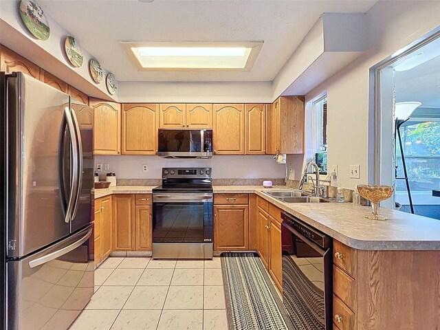 8640 Horizon Ln, Hudson, FL 34667 - kitchen featuring appliances with stainless steel finishes, a peninsula, light tile patterned floors, and light countertops