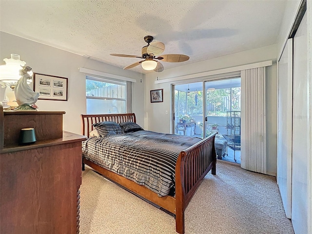 8640 Horizon Ln, Hudson, FL 34667 - bedroom featuring access to exterior, multiple windows, light colored carpet, a textured ceiling, and a ceiling fan