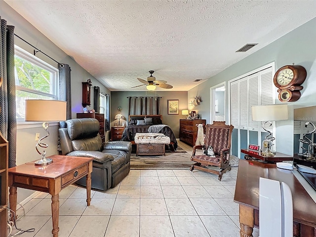 8640 Horizon Ln, Hudson, FL 34667 - living room with a textured ceiling, a ceiling fan, and light tile patterned floors