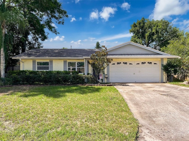 8640 Horizon Ln, Hudson, FL 34667 - single story home featuring a garage, driveway, a front yard, and stucco siding