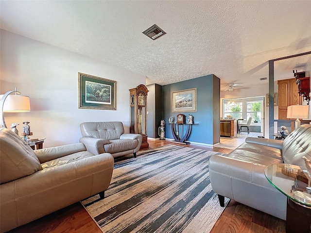 8640 Horizon Ln, Hudson, FL 34667 - living area featuring wood finished floors, a textured ceiling, and a ceiling fan