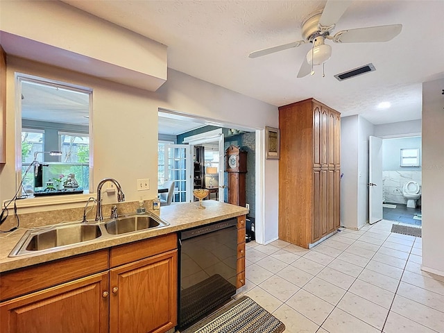 8640 Horizon Ln, Hudson, FL 34667 - kitchen featuring dishwasher, brown cabinets, ceiling fan, light tile patterned flooring, and light countertops
