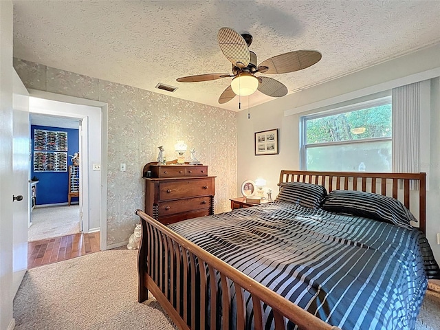 8640 Horizon Ln, Hudson, FL 34667 - bedroom featuring a textured ceiling, carpet, and a ceiling fan