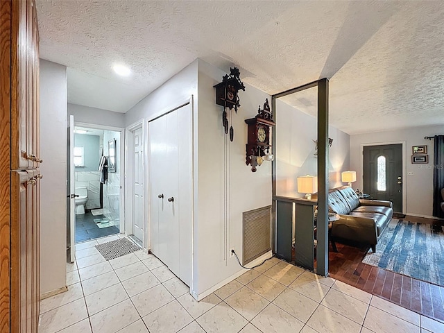 8640 Horizon Ln, Hudson, FL 34667 - corridor with a textured ceiling and light tile patterned flooring