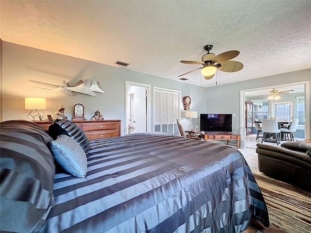 8640 Horizon Ln, Hudson, FL 34667 - tiled bedroom with a textured ceiling and a ceiling fan
