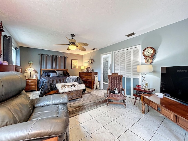 8640 Horizon Ln, Hudson, FL 34667 - bedroom featuring ceiling fan, light tile patterned floors, and a textured ceiling