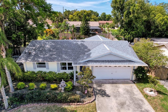 8640 Horizon Ln, Hudson, FL 34667 - ranch-style home with a shingled roof, an attached garage, driveway, and stucco siding