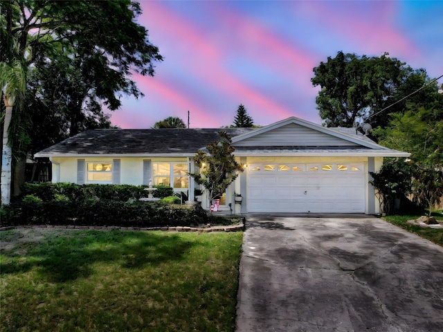 8640 Horizon Ln, Hudson, FL 34667 - ranch-style home featuring driveway, a yard, stucco siding, and an attached garage