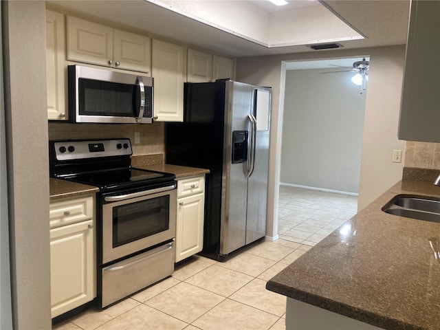 7806 Jenner Ave, New Port Richey, FL 34655 - kitchen with stainless steel appliances, backsplash, light tile patterned flooring, and a ceiling fan