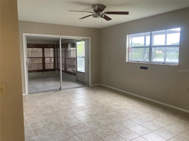 7806 Jenner Ave, New Port Richey, FL 34655 - unfurnished room with light tile patterned flooring, a ceiling fan, and a textured ceiling