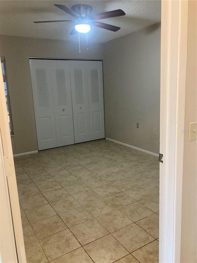 7806 Jenner Ave, New Port Richey, FL 34655 - unfurnished bedroom featuring a closet, light tile patterned floors, and a ceiling fan