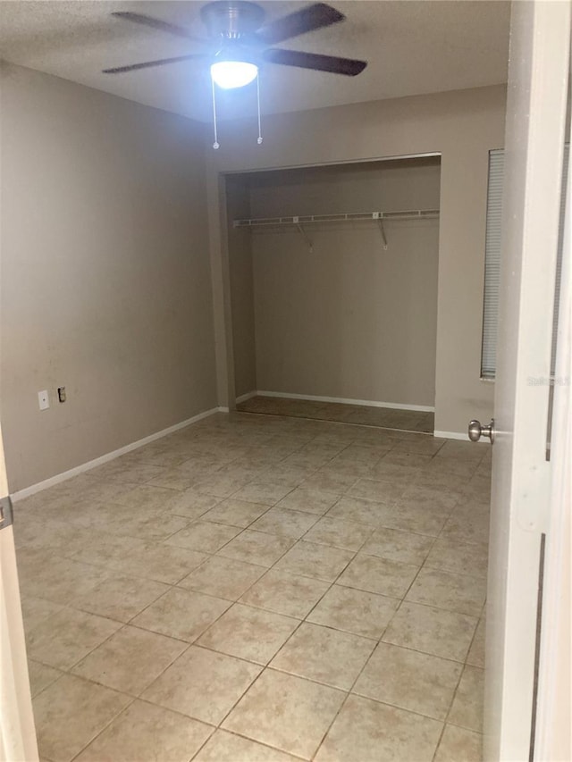 7806 Jenner Ave, New Port Richey, FL 34655 - unfurnished bedroom with a closet, light tile patterned flooring, and a ceiling fan