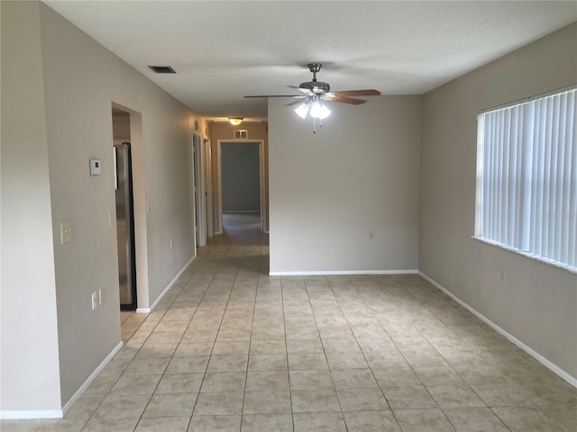 7806 Jenner Ave, New Port Richey, FL 34655 - unfurnished room with a ceiling fan and light tile patterned floors