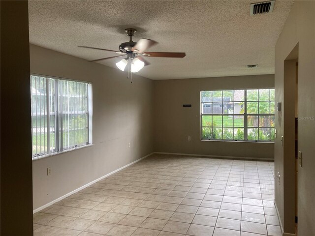 7806 Jenner Ave, New Port Richey, FL 34655 - spare room with a ceiling fan, light tile patterned floors, and a textured ceiling