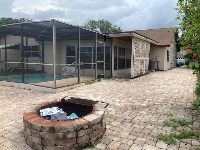 7806 Jenner Ave, New Port Richey, FL 34655 - view of patio / terrace featuring an outdoor fire pit, an outdoor pool, and a lanai