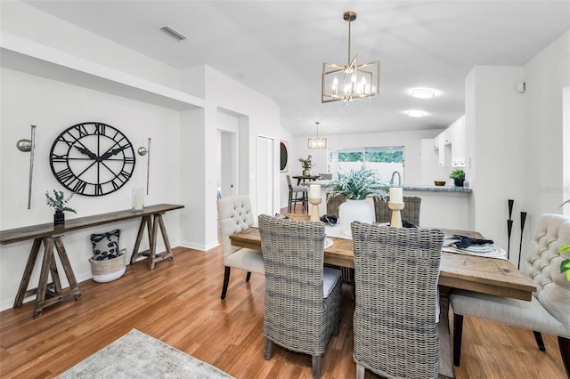 11619 Crest Creek Dr, Riverview, FL 33569 - dining area featuring a chandelier and light wood-style flooring