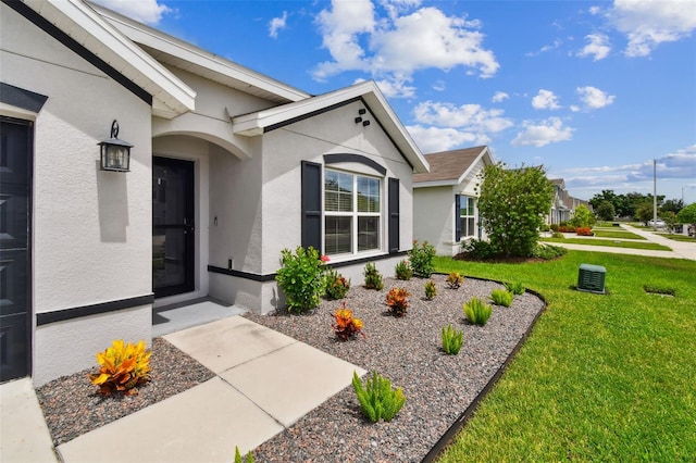 11861 Downy Birch Dr, Riverview, FL 33569 - doorway to property featuring stucco siding and a yard