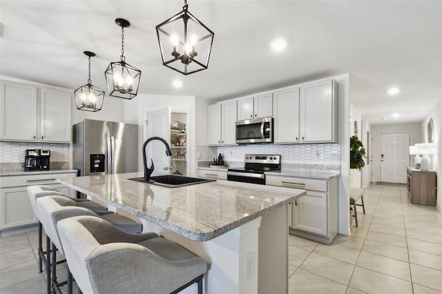 11861 Downy Birch Dr, Riverview, FL 33569 - kitchen featuring stainless steel appliances, light tile patterned flooring, decorative backsplash, a chandelier, and recessed lighting