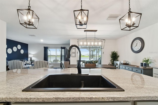 11861 Downy Birch Dr, Riverview, FL 33569 - kitchen with a chandelier, open floor plan, and hanging light fixtures