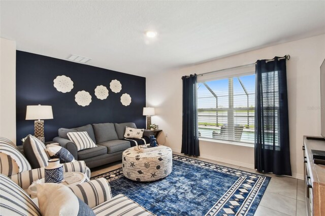 11861 Downy Birch Dr, Riverview, FL 33569 - living area featuring an accent wall and light tile patterned flooring