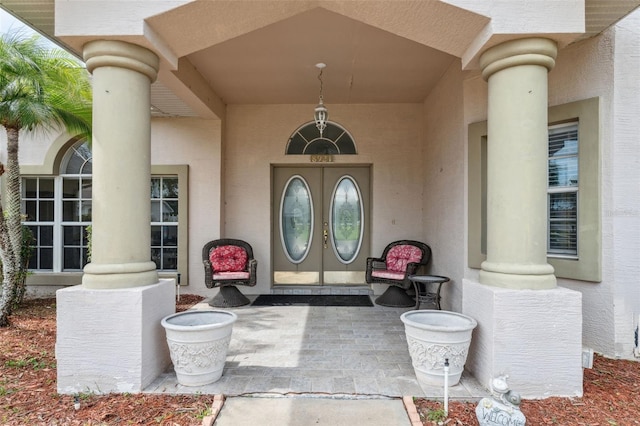 8921 Kilmer Way, Hudson, FL 34667 - doorway to property with french doors and stucco siding